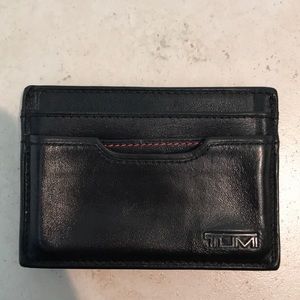Men’s black Tumi money clip wallet